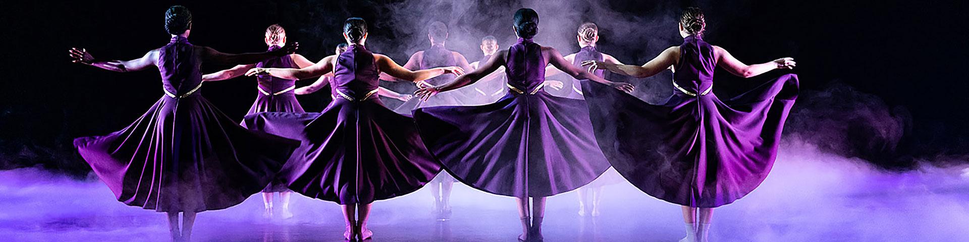 dancers in purple gowns